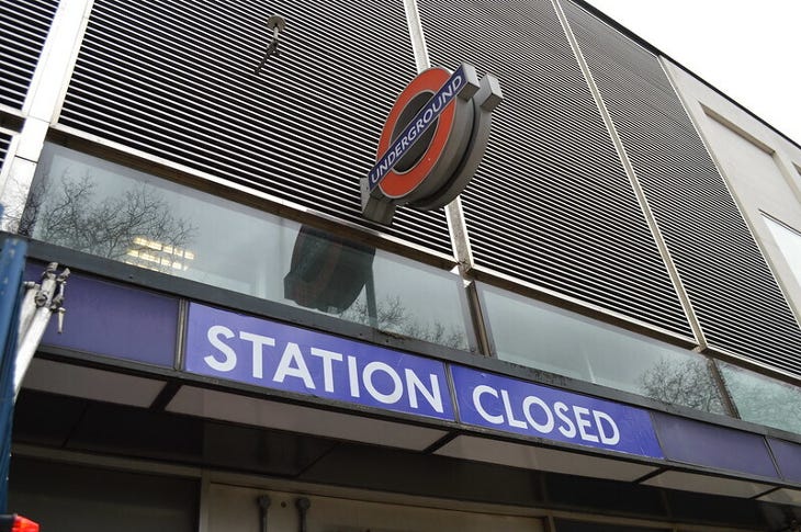 Exterior of a tube station with a 'Station Closed' sign