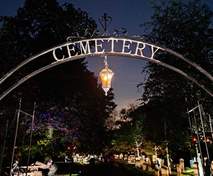 A metal cemetery entrance arch