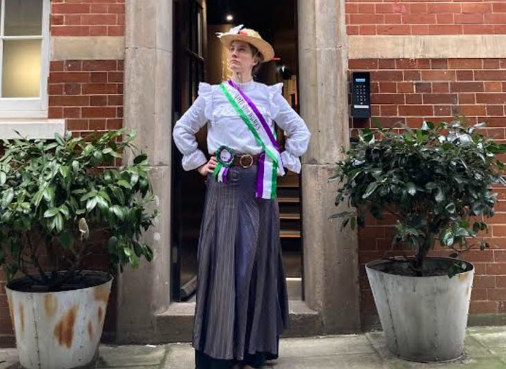 A guide dressed as a suffragette at the door to the Bow Street Police Museum