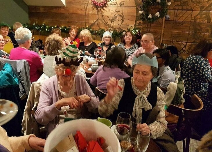 Lots of merry-makers enjoying christmas dinner in a pub