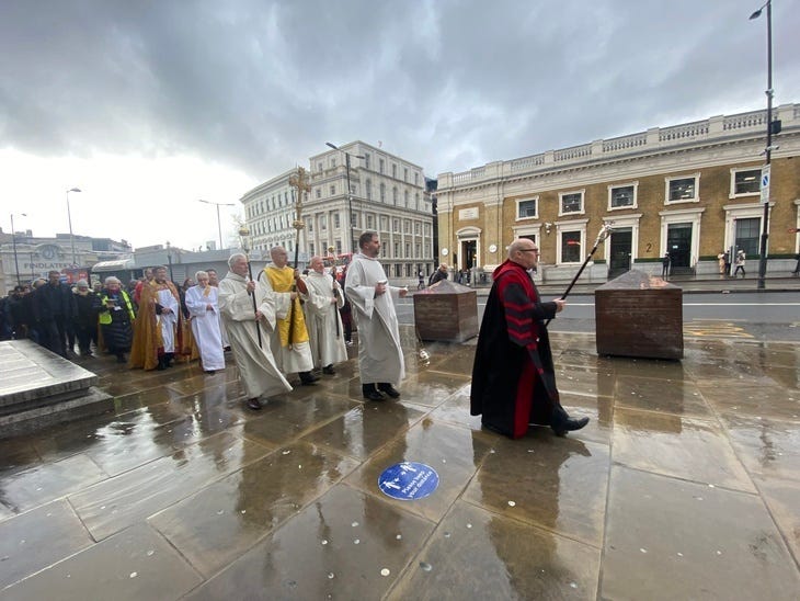Members of the clergy leading a procession towards London Bridge