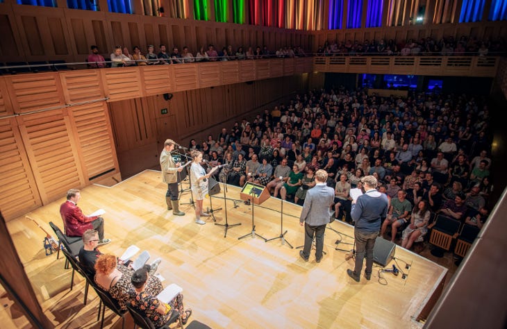 A group of people on stage in front of an audience