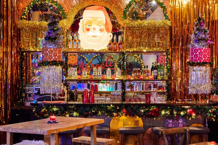 A bar completely covered in tinsel and other Christmas decorations