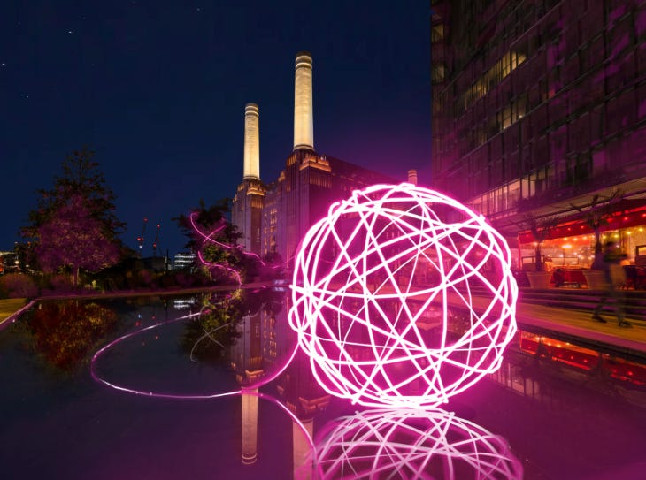 A giant glowing ball of yarn in front of Battersea Power Station