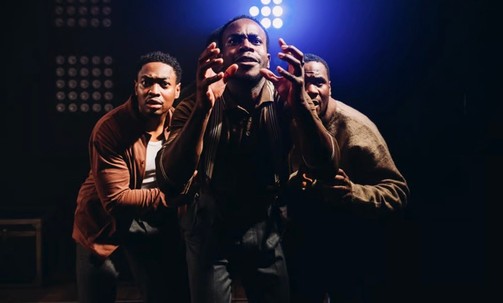 Four young men staring at the camera lens