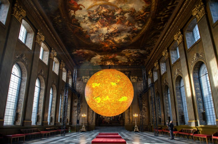 A giant glowing yellow orb inside the Painted Hall