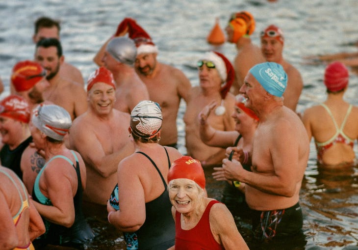 People in cold water/Christmas hats