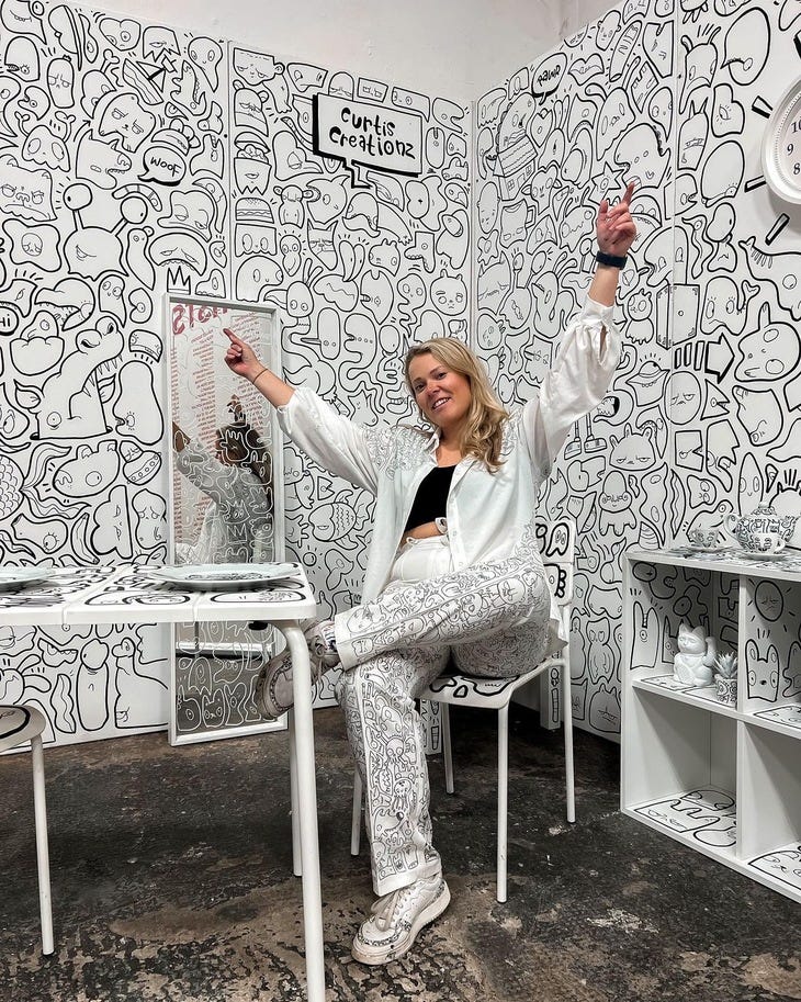 An artist in a room full of doodles