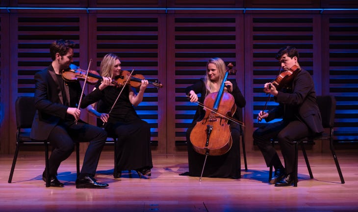 A string quartet performing on stage