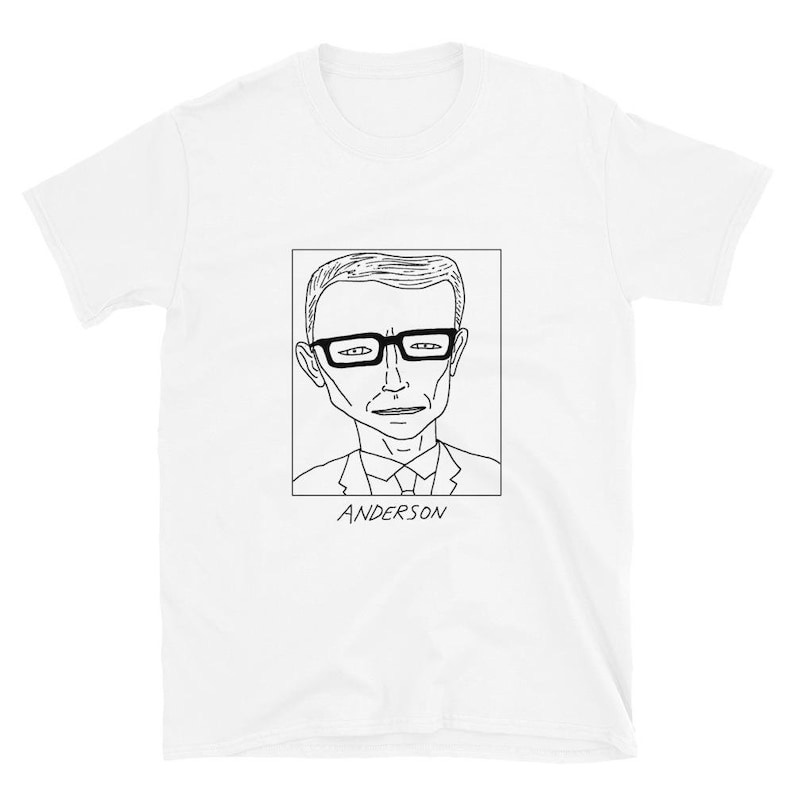 May include: A white t-shirt with a black line drawing of a man wearing glasses and a suit. The drawing is in a square frame with the word 'ANDERSON' underneath.