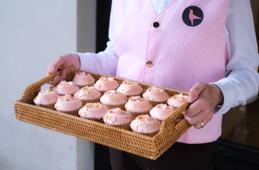 A tray of pink iced cupcakes