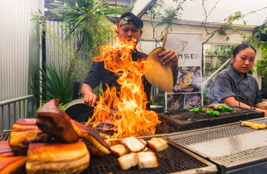 A chef cooking something on flames