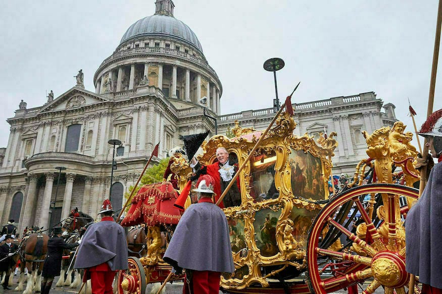 A former Lord Mayor riding in a gold state coach past St Paul's Cathedral