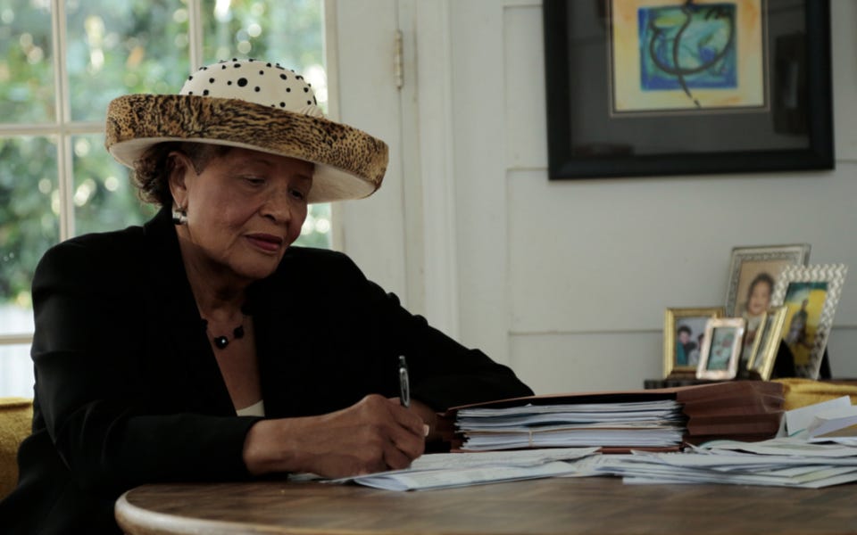 Congresswoman Adams at her desk, writing