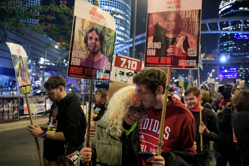 People in Tel Aviv react to the news of an Israel-Hamas ceasefire.