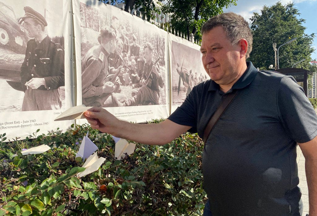 A man places a paper plane outside the French embassy in Moscow.