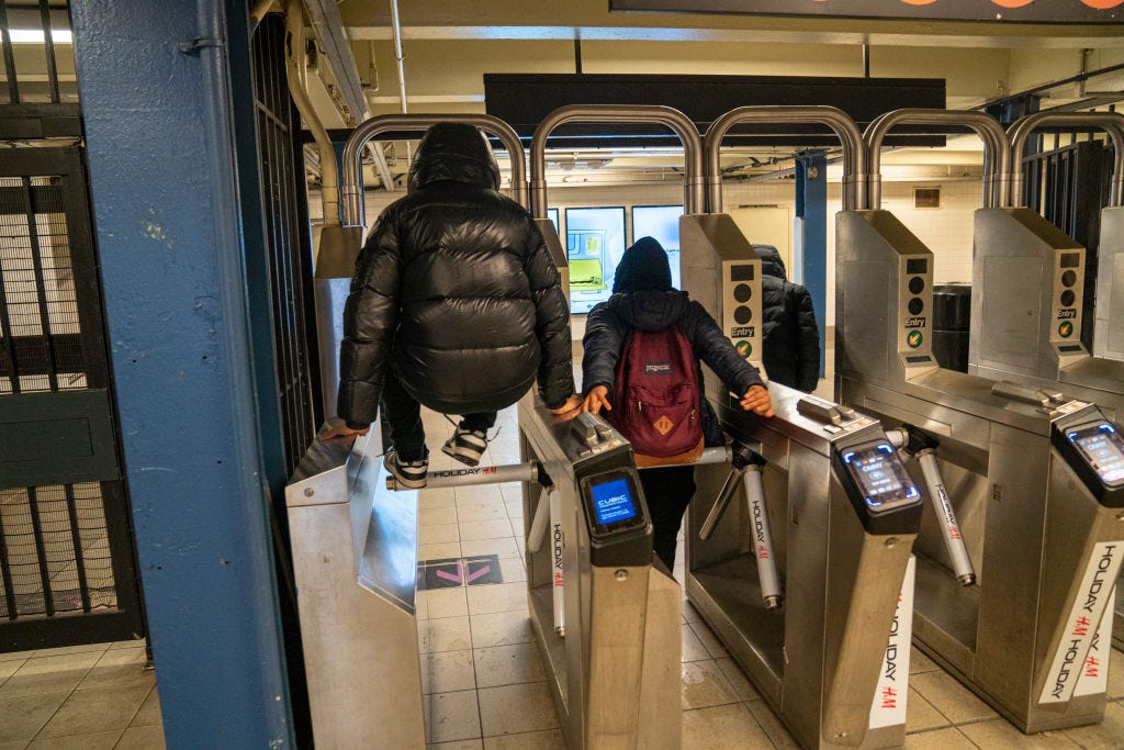 A teenager jumps a turnstile.