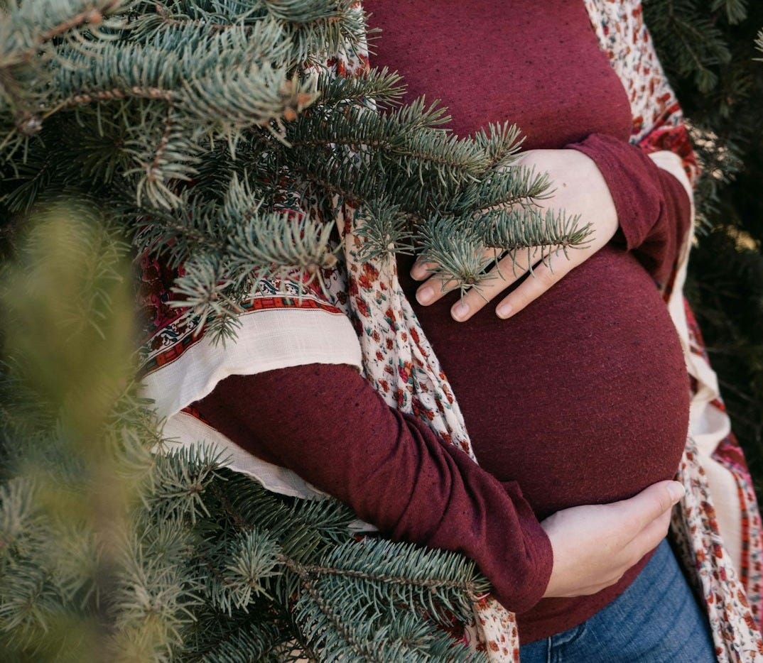 woman in red and white long sleeve shirt and red pants sitting on red chair