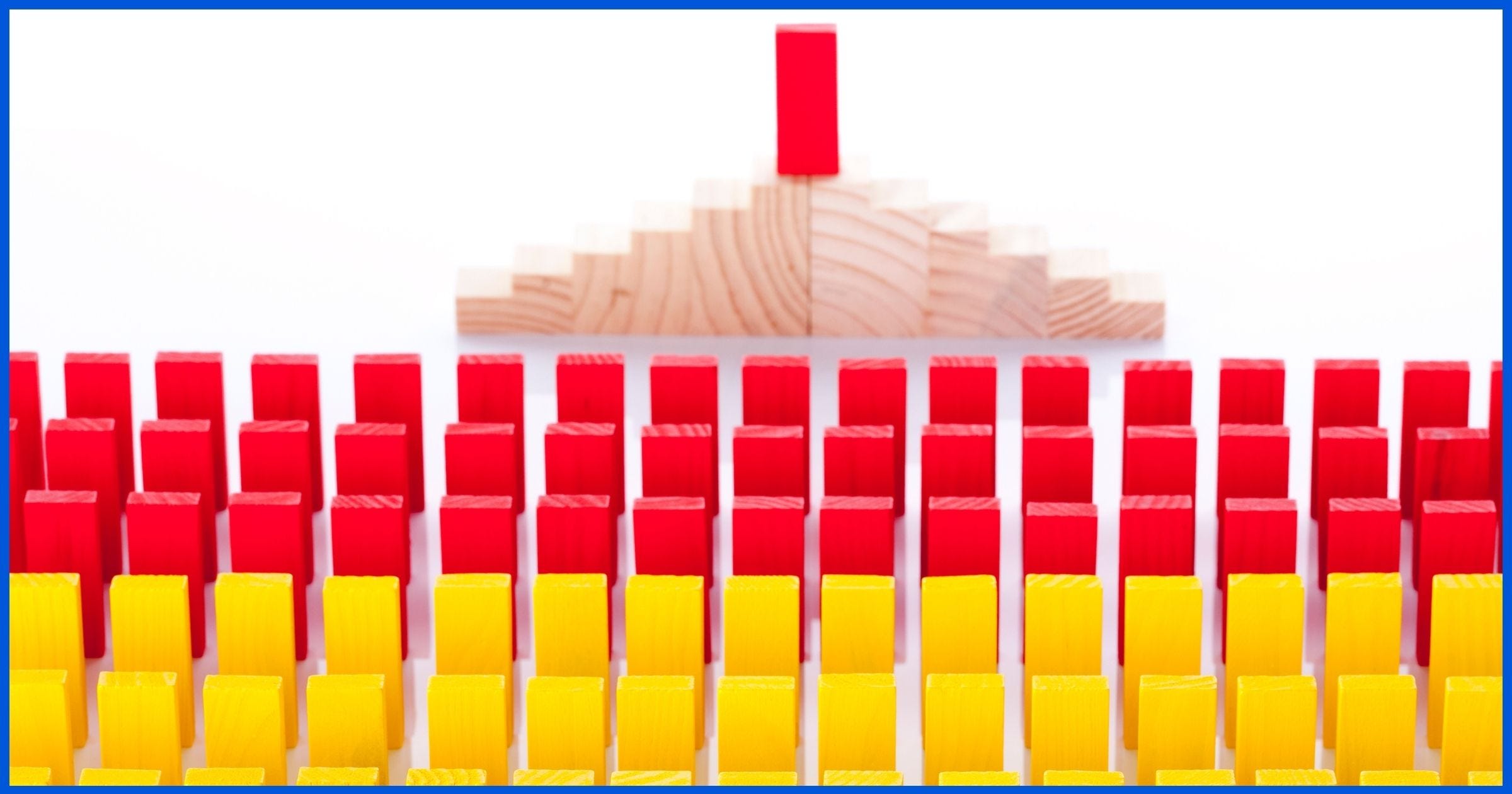 Rows of brightly colored blocks in front of a red block on a pedestal presumably giving a pep-talk.