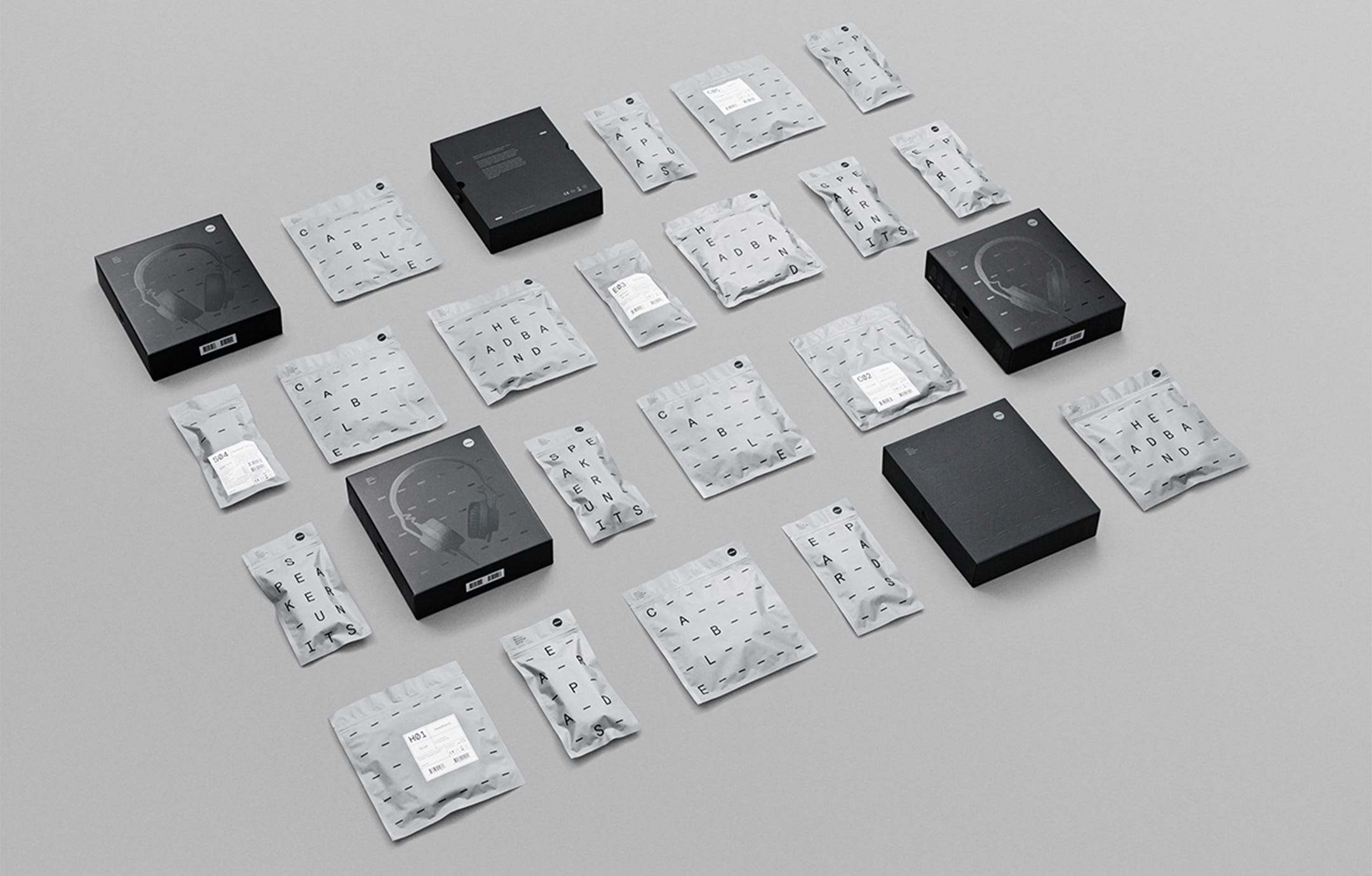 A grid of packages—both boxes and bags—in silver and black with a type-driven design
