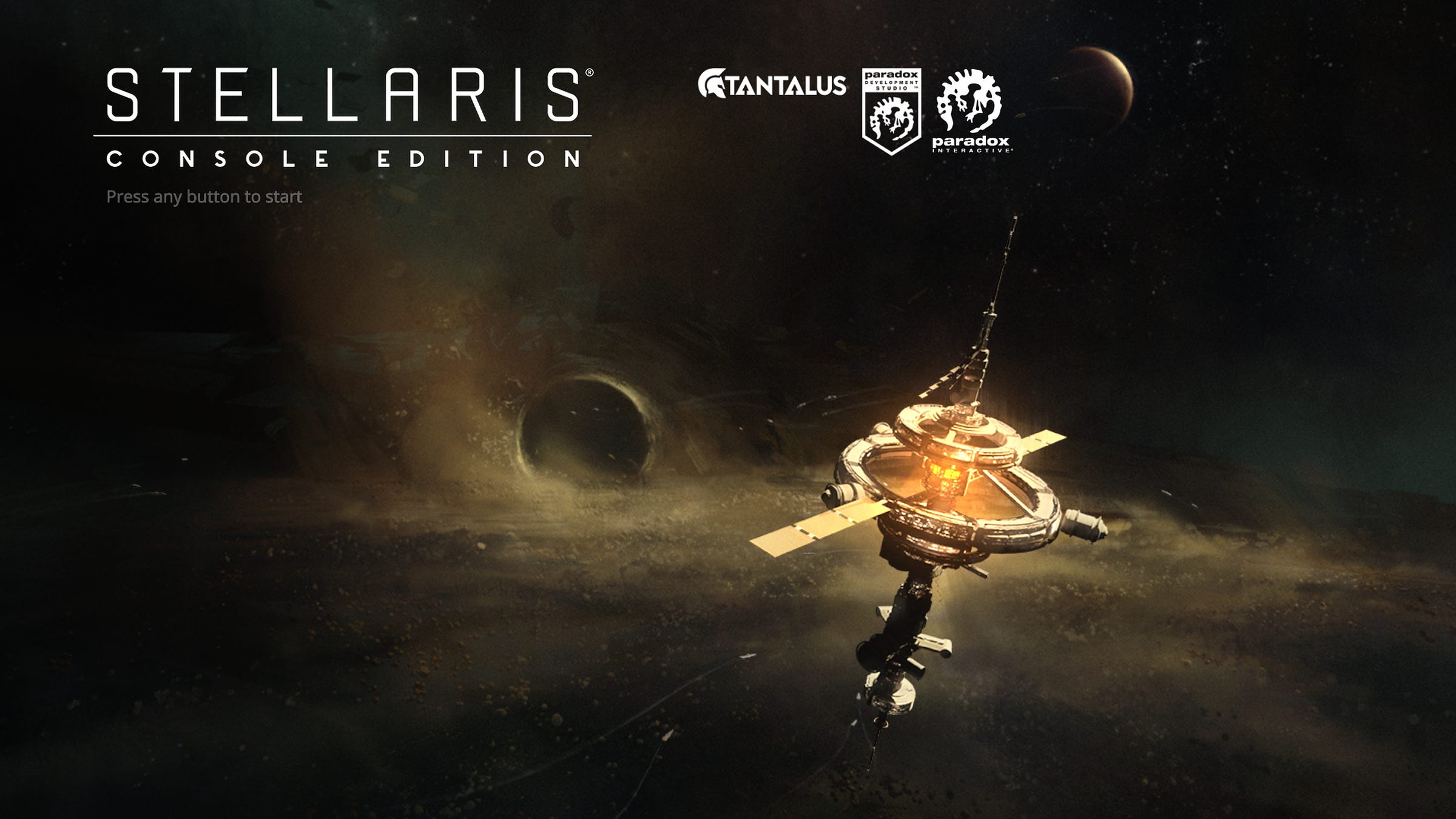 Title screen for Stellaris: Console Edition, with a space station in deep space.