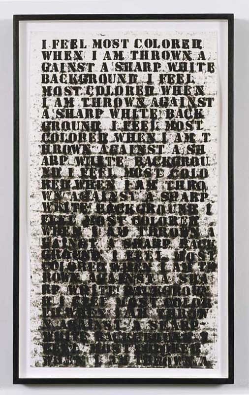 Image of black stenciled letters against a white background. The text, in all caps, reads, "I feel most colored when I am thrown against a sharp white background." The text repeats over and over and as it goes down, the text becomes blurrier and smudgier until it's almost unreadable and less contrasted with the white background.