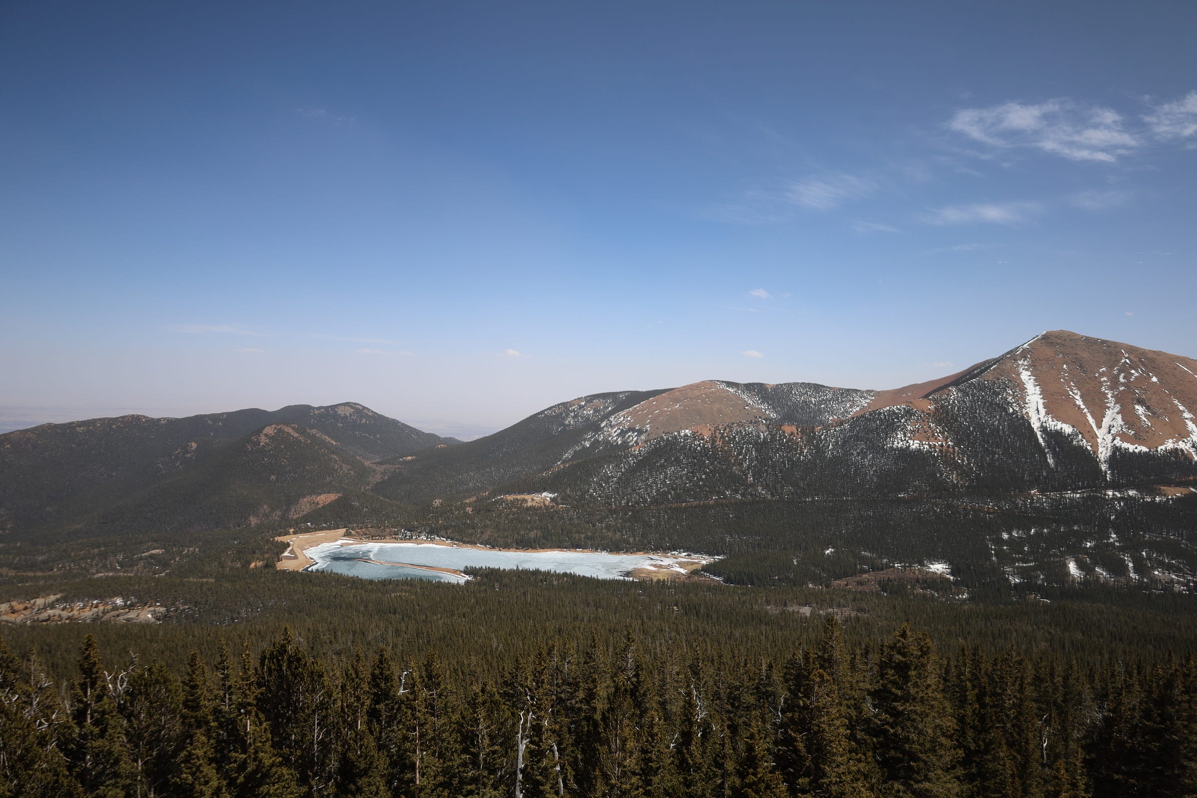 a clear sky above calendar peak, with a mountain lake in the foreground