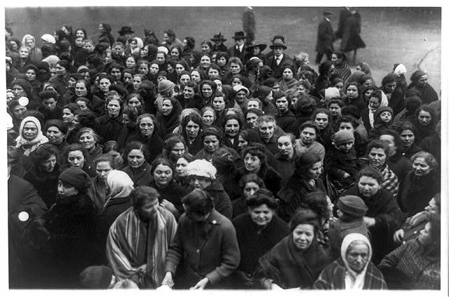 Historic photo of a crowd of women in immigrant attire on the street in New York, 1917.