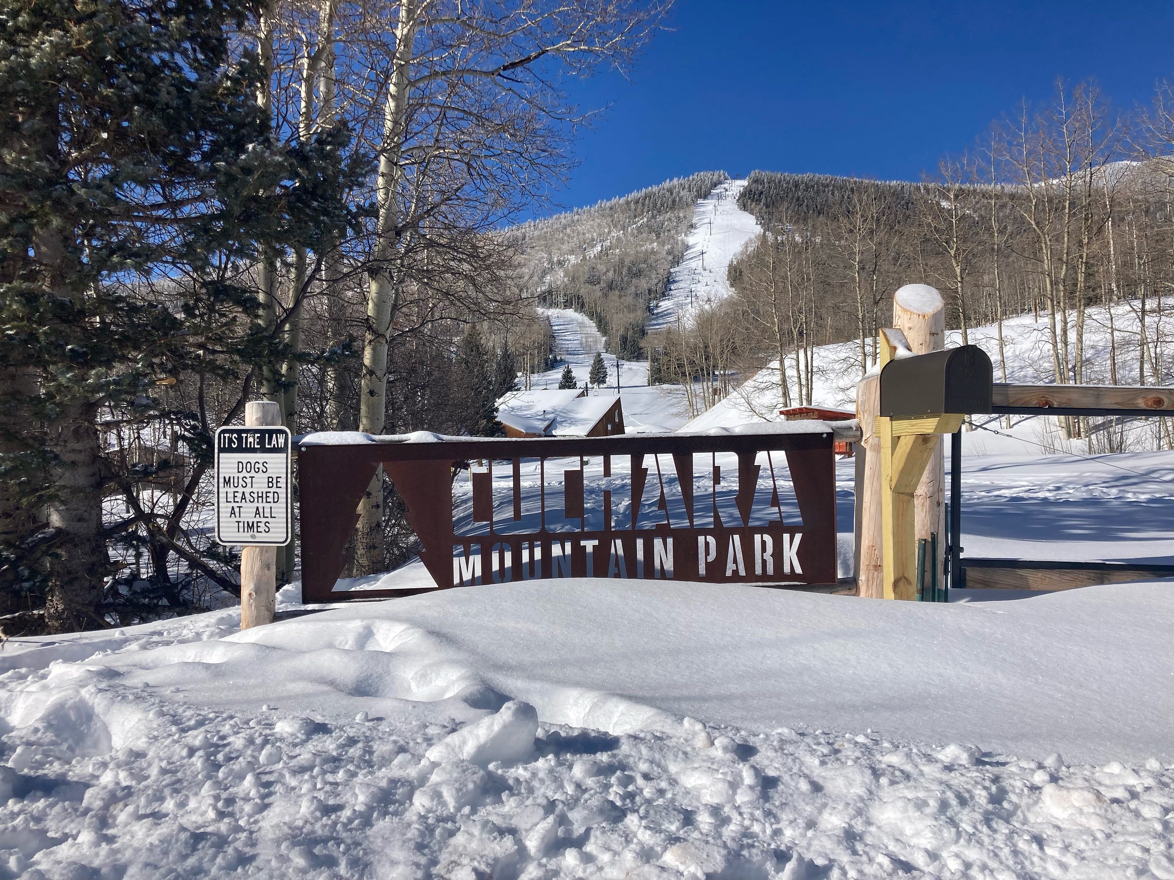 a sign reads "cuchara mountain park." in the background, a chair lift heads up the hill and out of sight.
