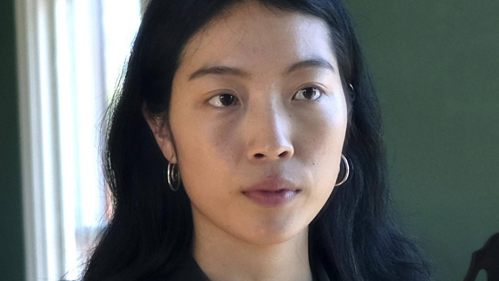 Close-cropped portrait of Mindy Seu, who is wearing silver hoop earrings and looking off to the side