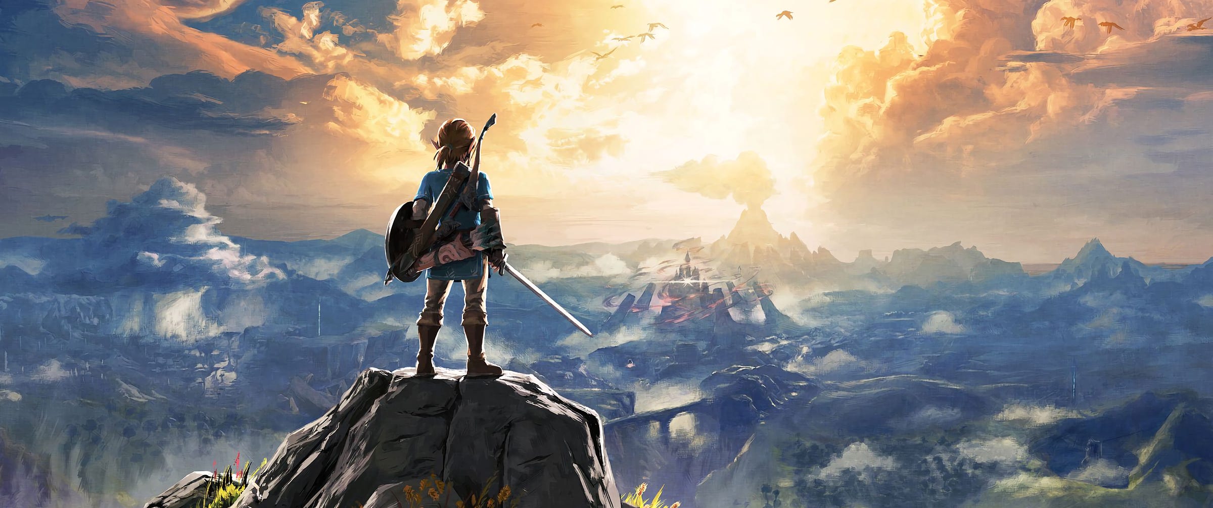 A young man in a blue shirt holding a sword and shield, with a bow and sheath draped across his back and a quiver on his belt, looks out over a vast mountainous landscape at sunset. A castle surrounded by red fog sits far in the distance.