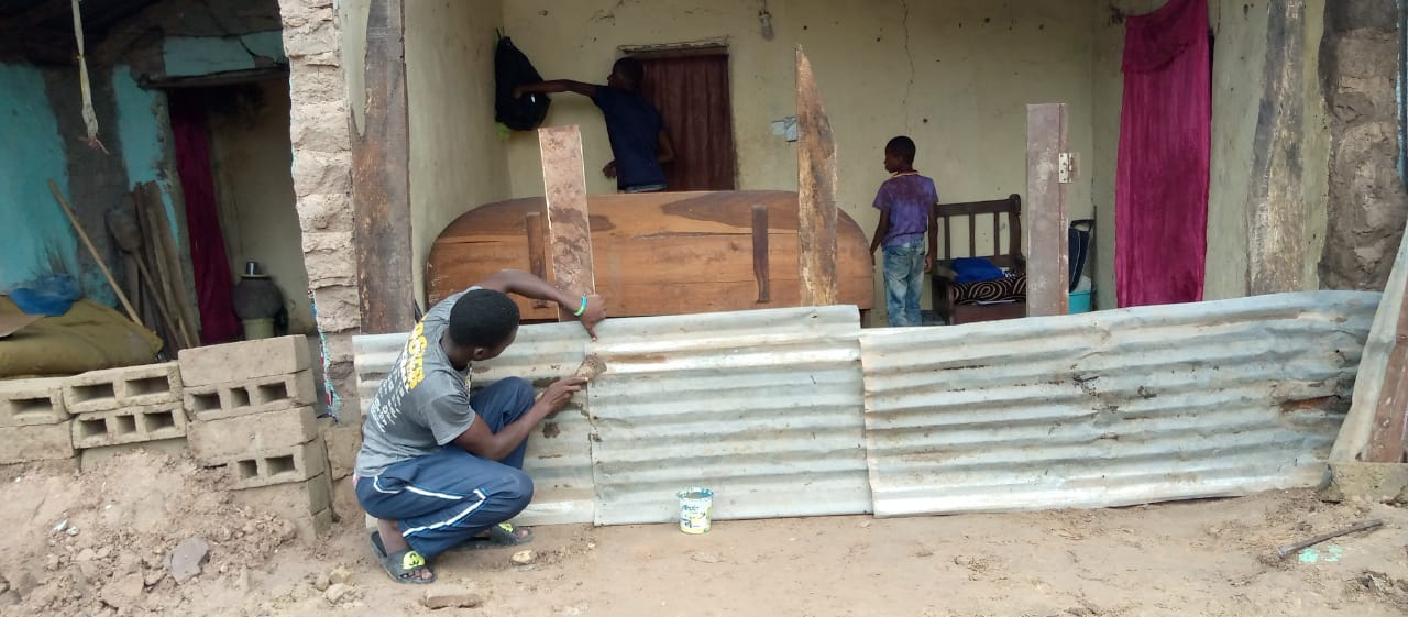 The author works to repair a neighbor’s damaged house.