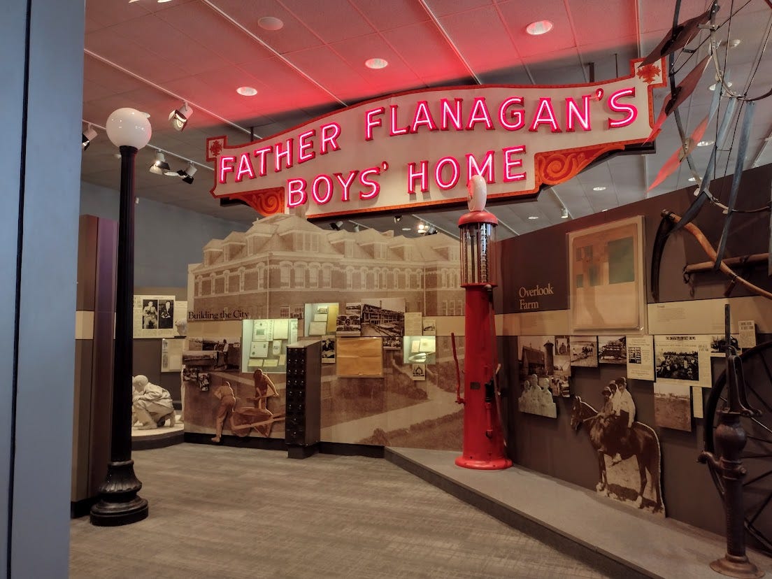 Museum interior with neon sign for Father Flanagan's Boys Home