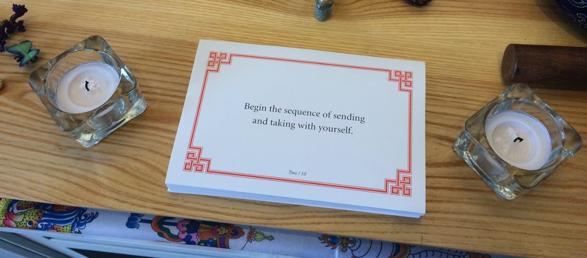 Lojong slogan card on a shrine with text: Begin the sequence of sending and taking with yourself.