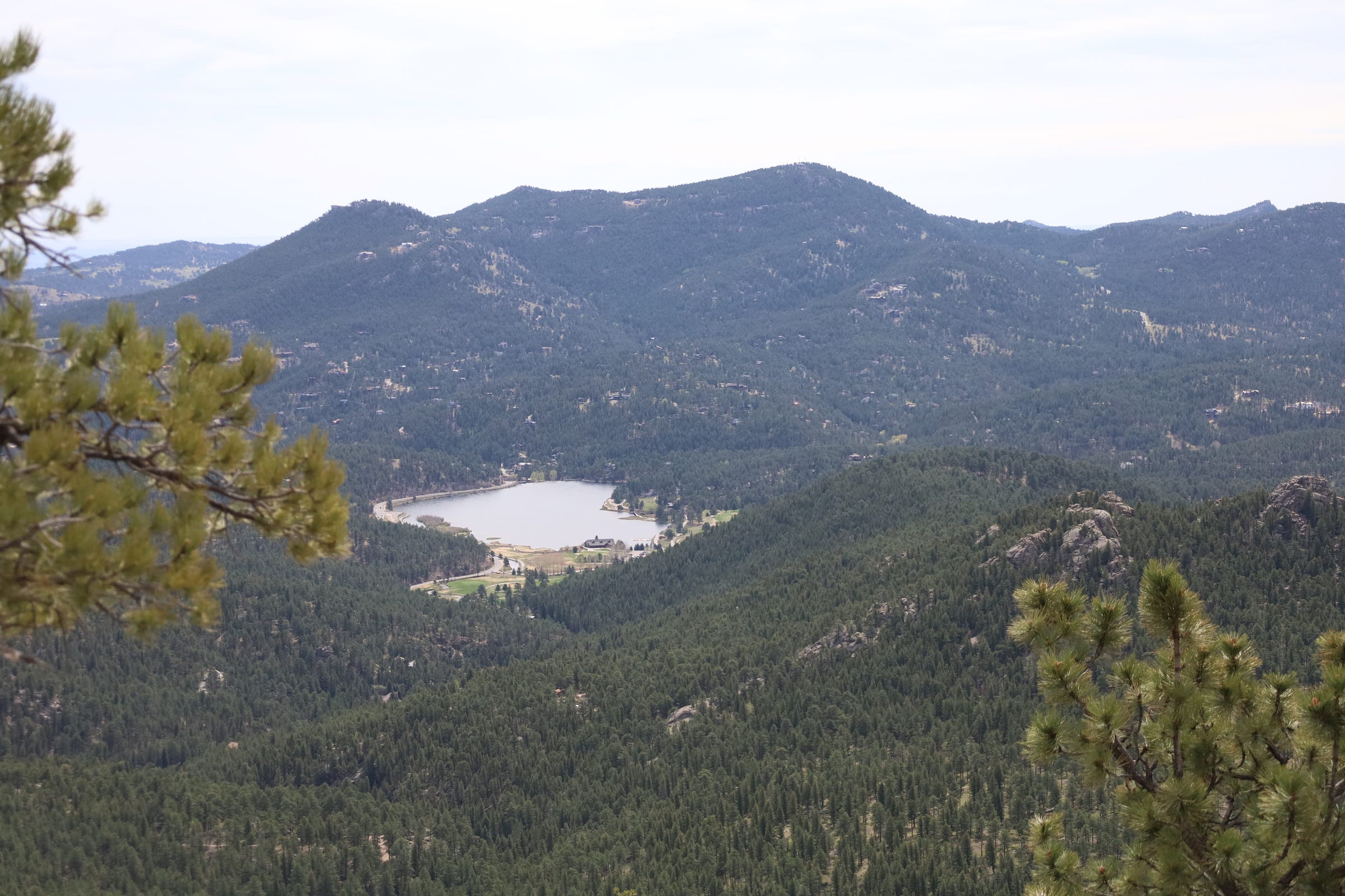 Evergreen lake, nestled between craggy, pine-covered mountains