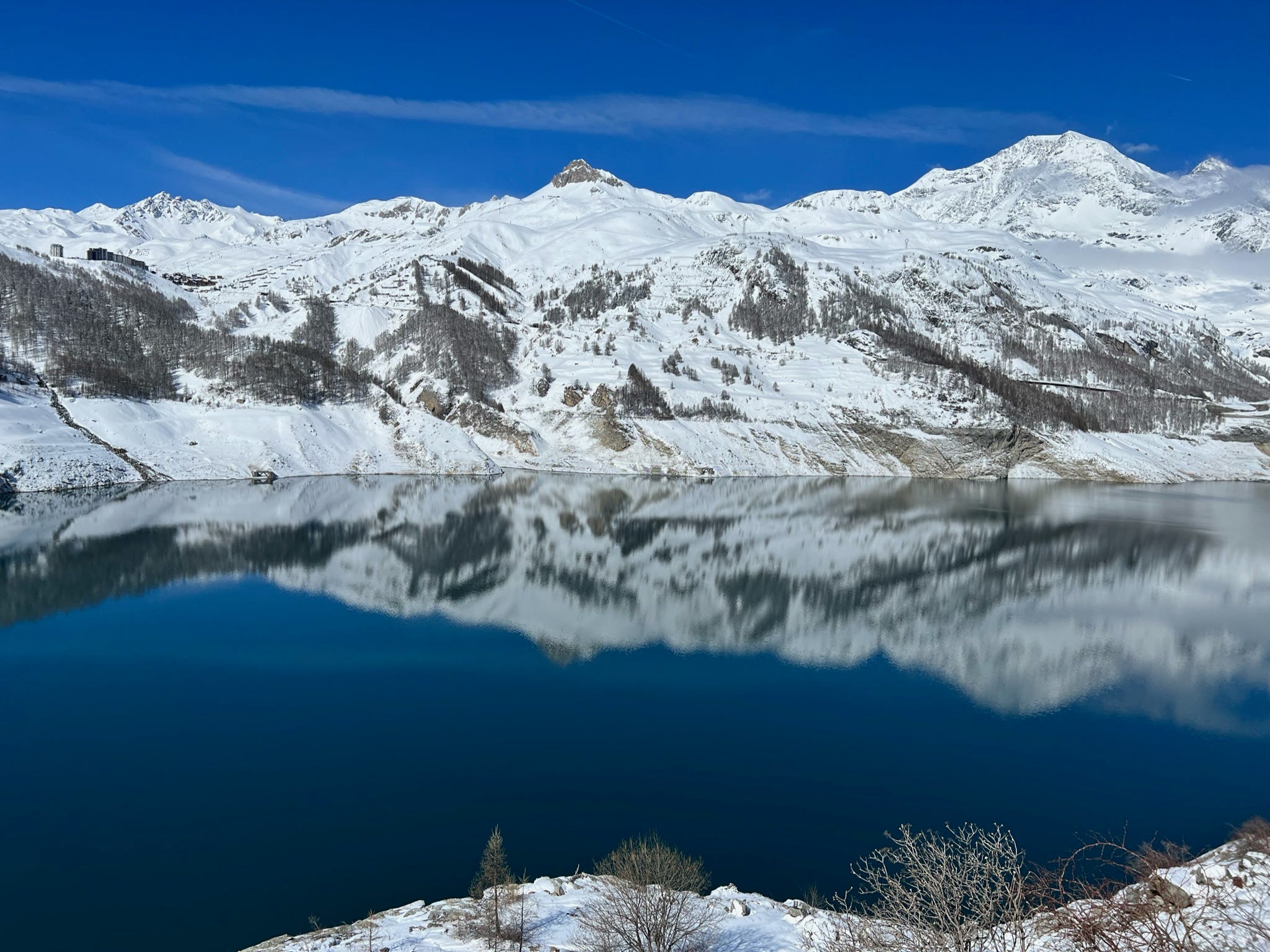 A photo of snowy mountains overlooking a lake.