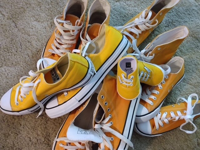 pile of yellow converse shoes