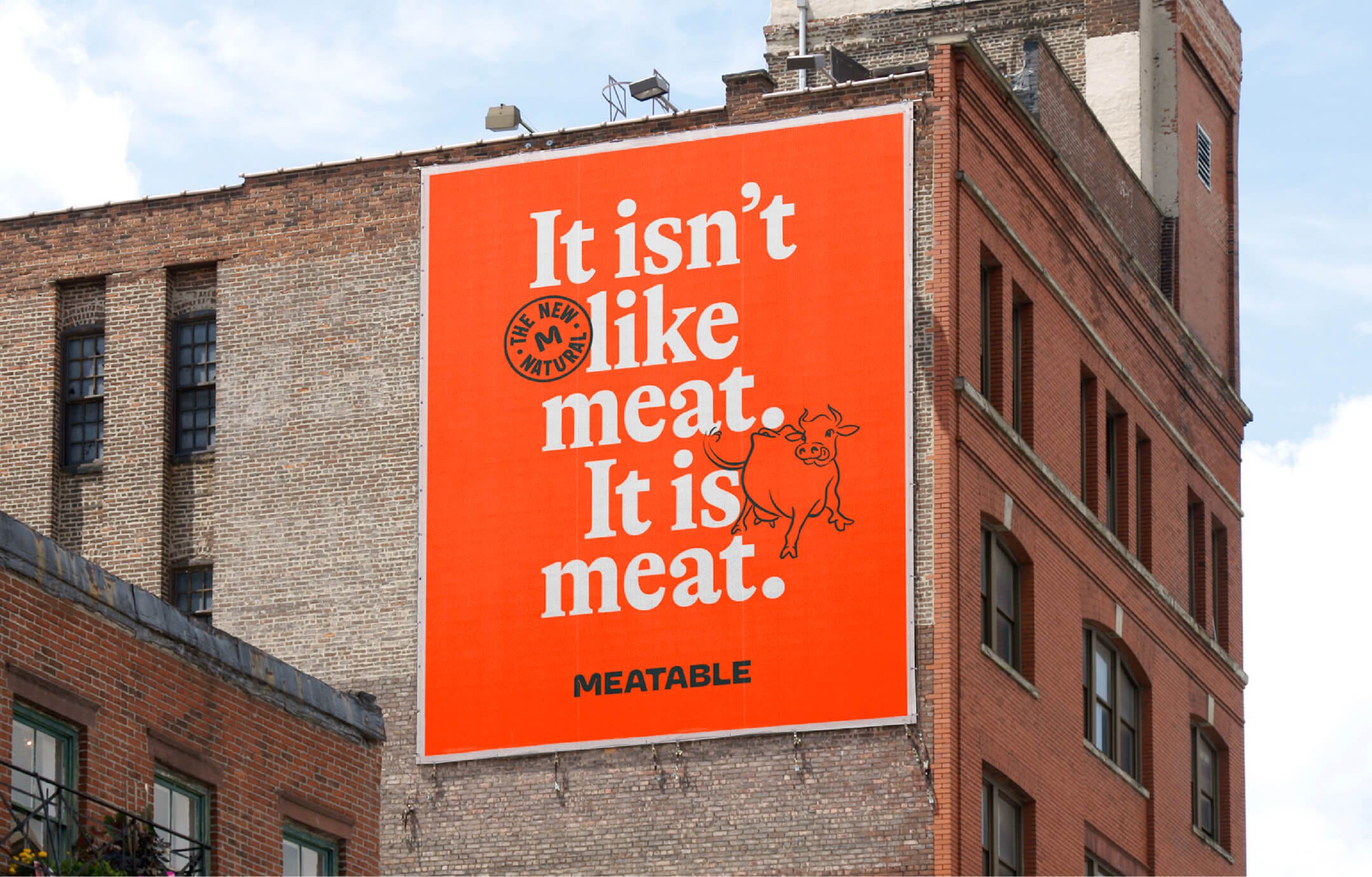 Billboard on the side of a building that reads "It isn't like meat. It is meat."