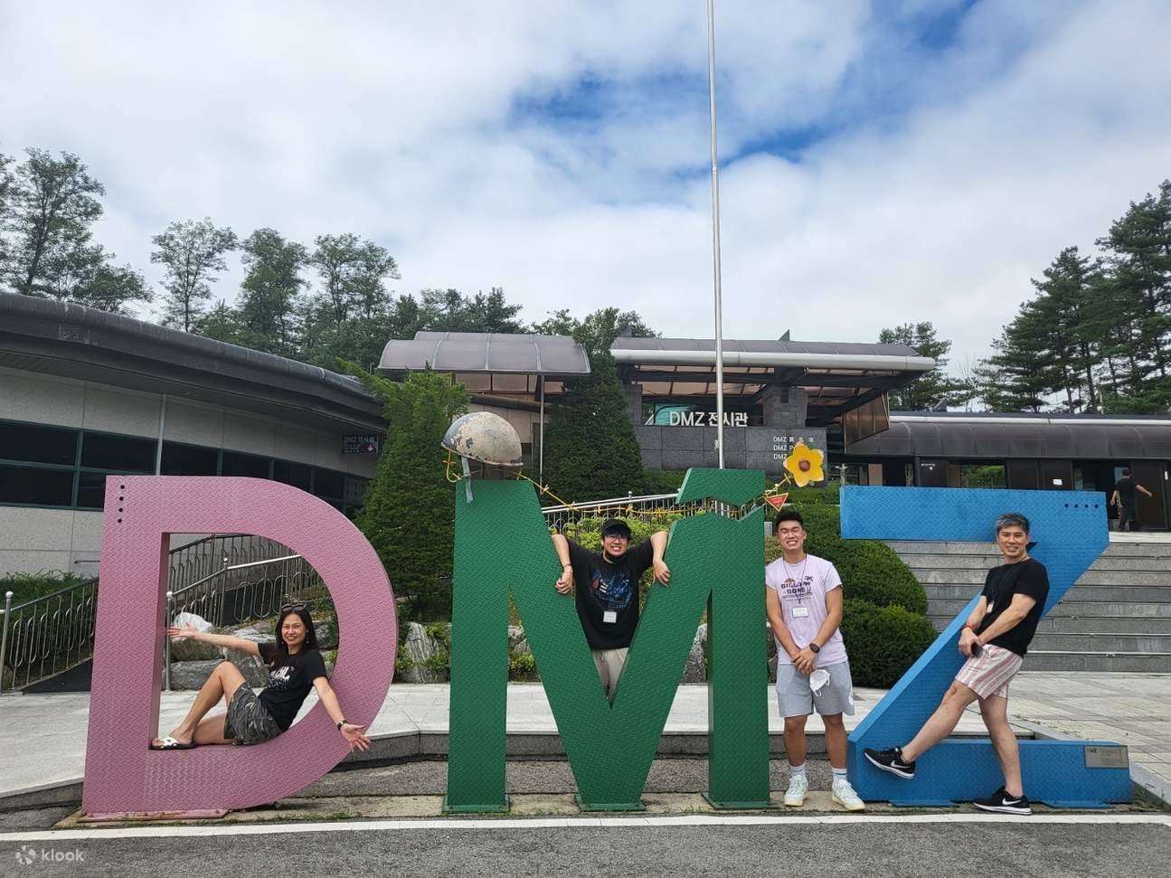 students pose with DMZ sign in Korea