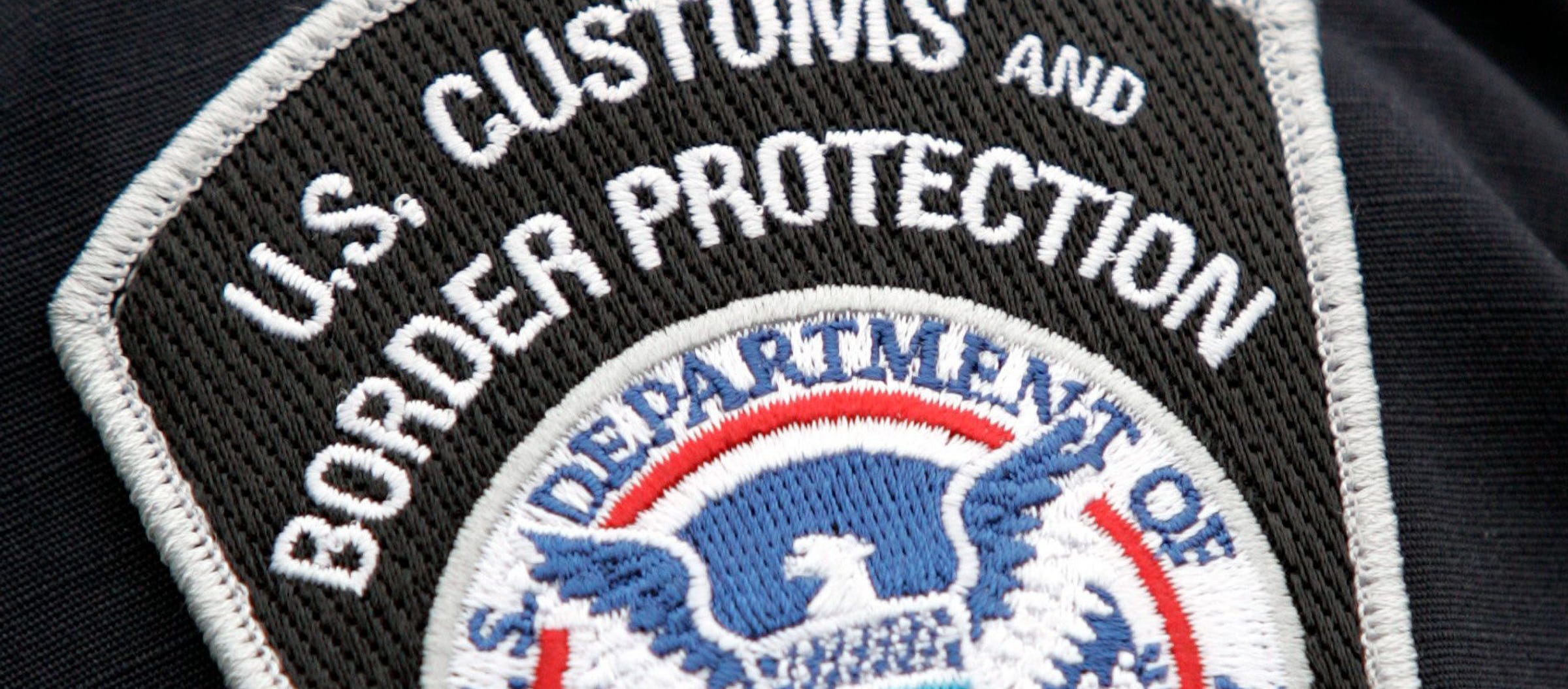 Very tight close up photo of a U.S. Customs and Border Agent sleeve badge