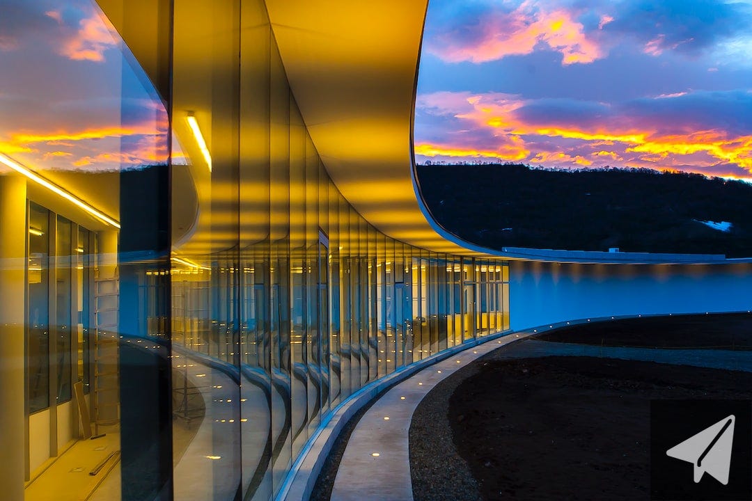 clear glass wall building under blue sky with clouds clear glass wall building under blue sky with clouds