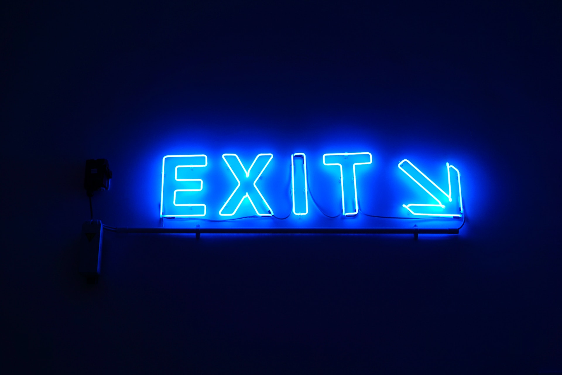 A neon exit sign. A neon exit sign.