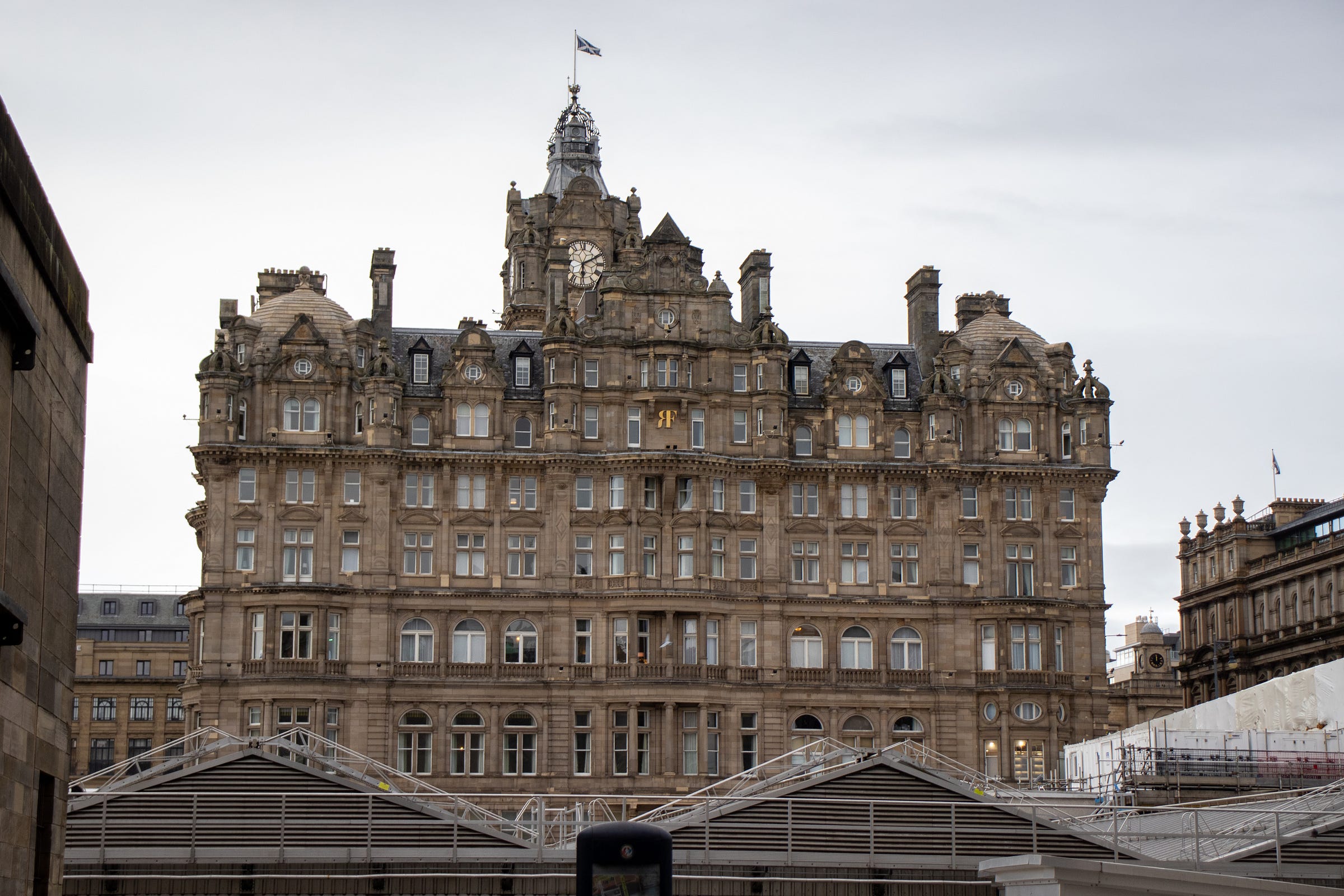 Large ornate building in central Edinburgh with multiple windows, turrets and a prominent clock tower.