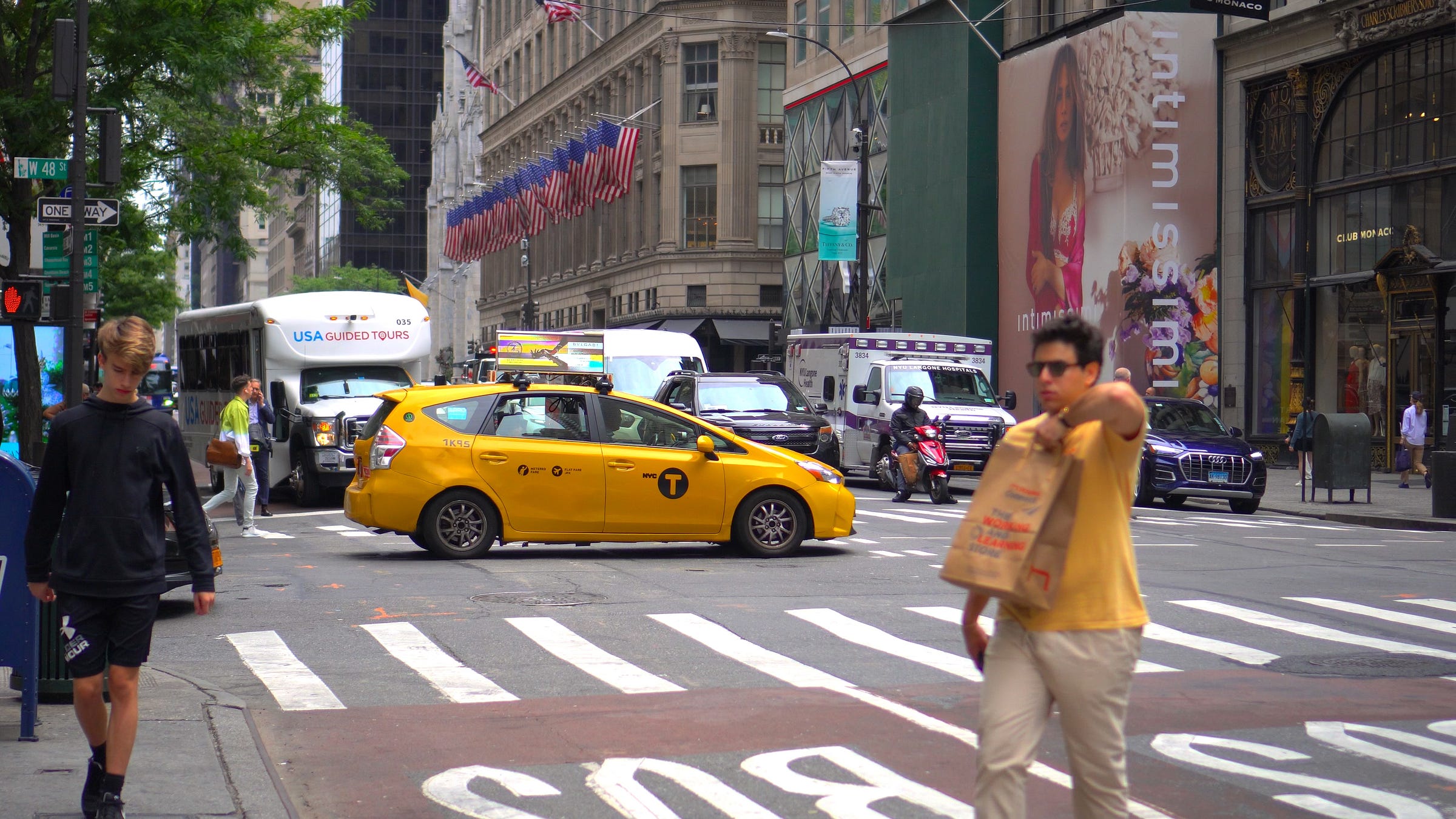 A yellow cab driving through a congested NYC street