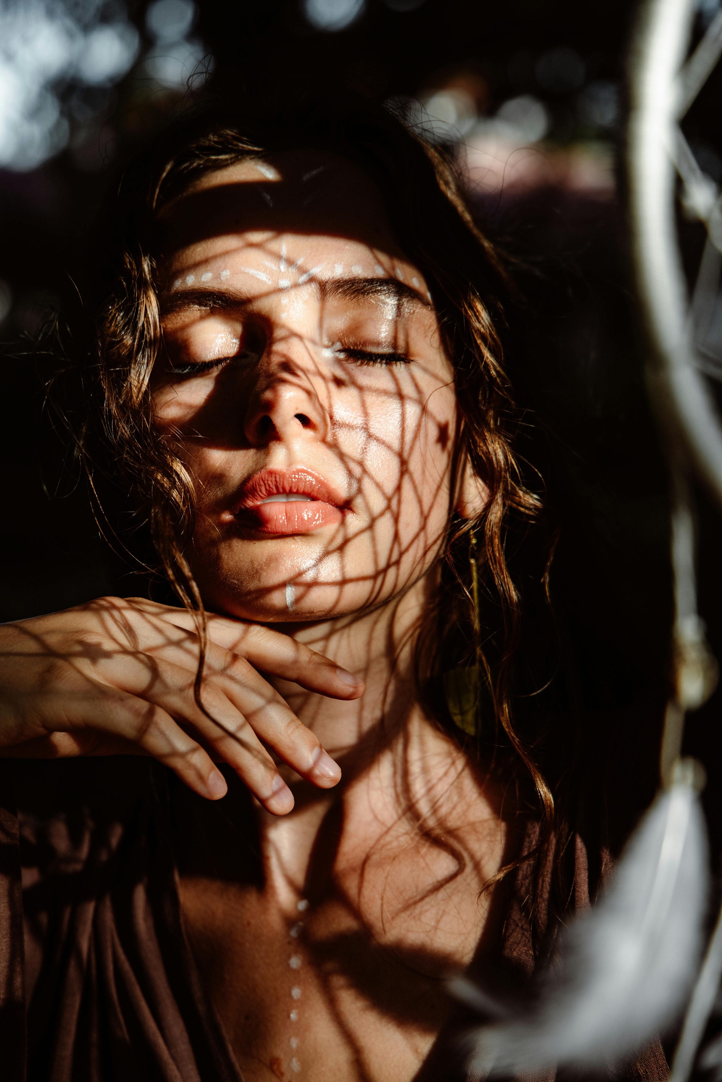 Veiled storm. A woman with closed eyes and shadows on her face. Veiled storm. A woman with closed eyes and shadows on her face.