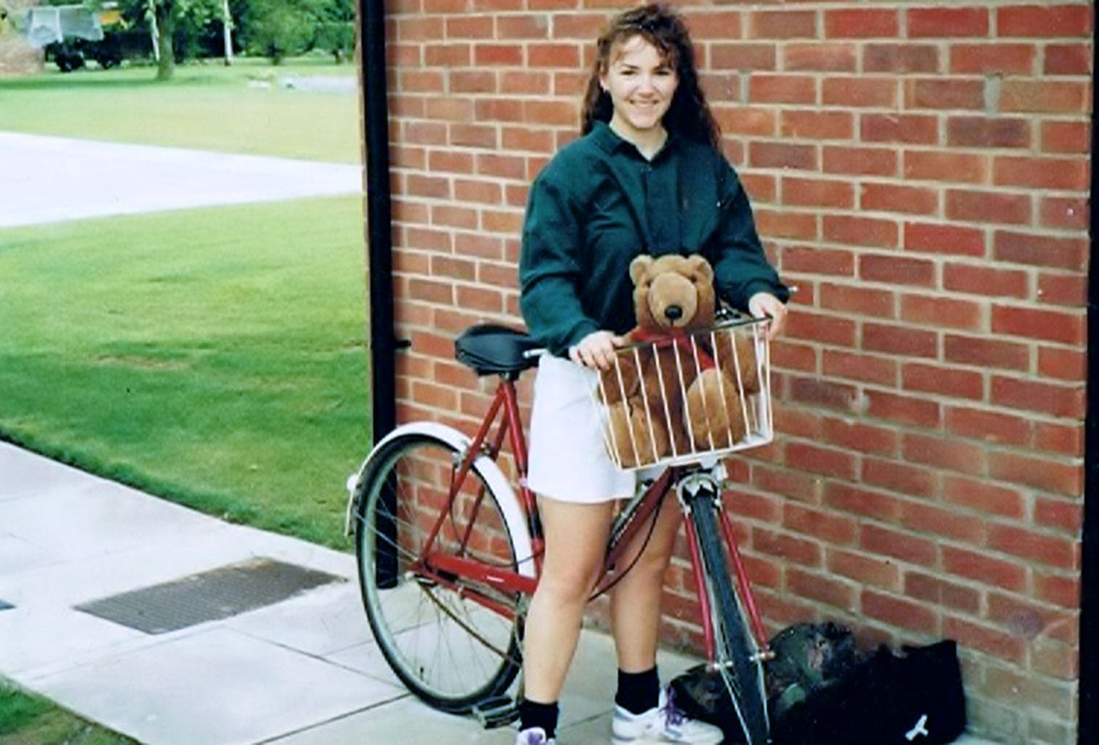 Tina continues the age of great avoidance by travelling overseas as a student. She stands in front of a brick wall with a bicycle and her favour teddy. Did we mention she's 23?
