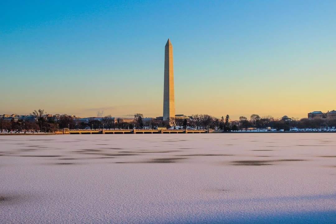 Photo of the Washington Monument on a cold, winter morning. The Tidal Basin is covered in ice & snow.