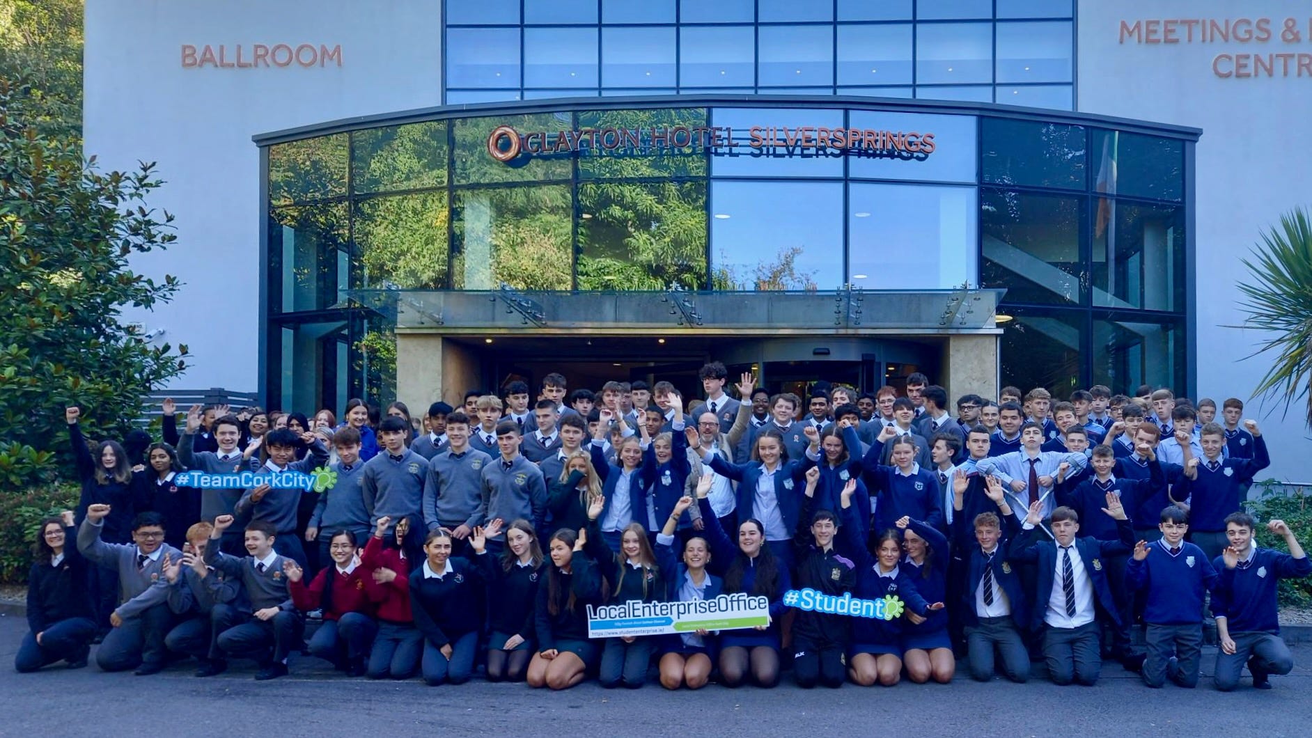 Oliver Moran standing in the middle of a very large group of students from across Cork at the launch of the Student Enterprise Programme at the Clayton Hotel Silversprings.