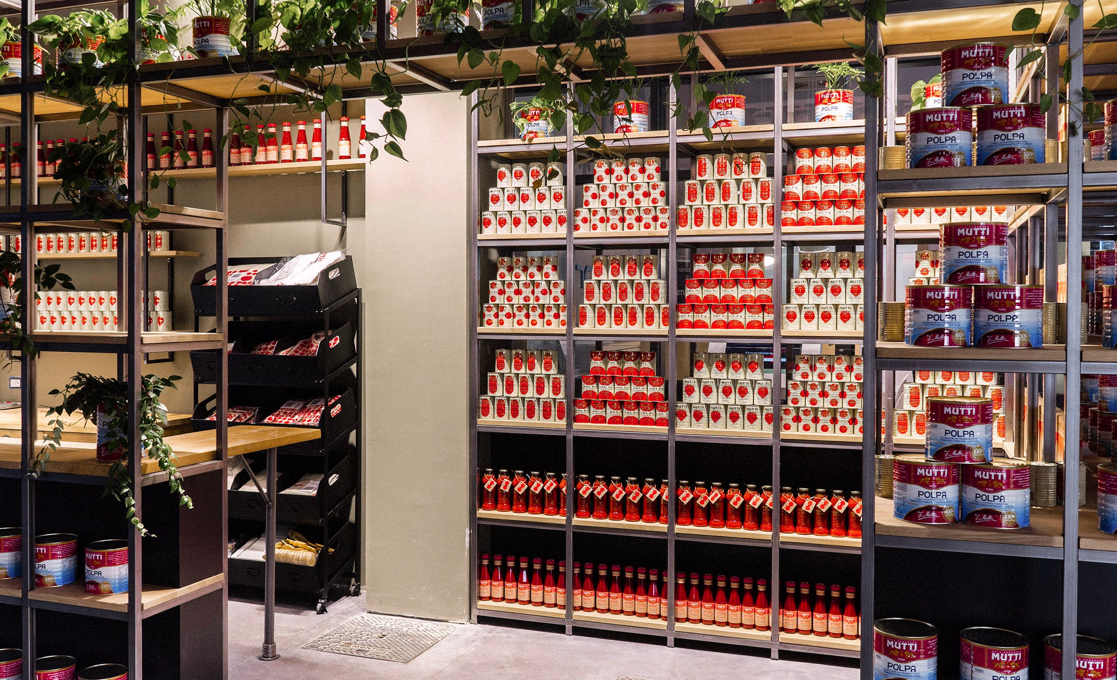 A shop stocked with many of the Mutti tins, forming red and cream patterns when viewed from afar.