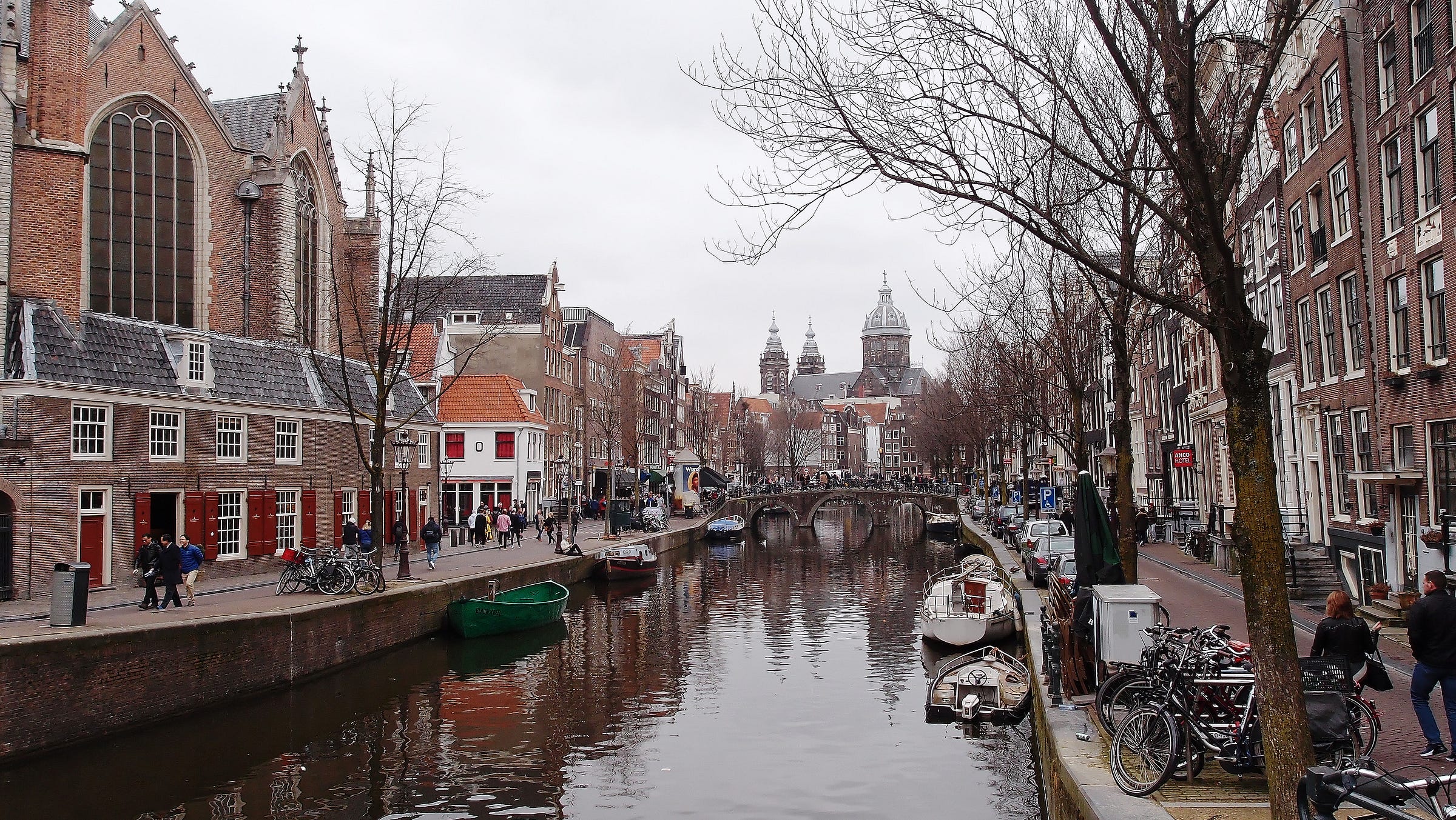 Picture of a street in Amsterdam with a canal running through it